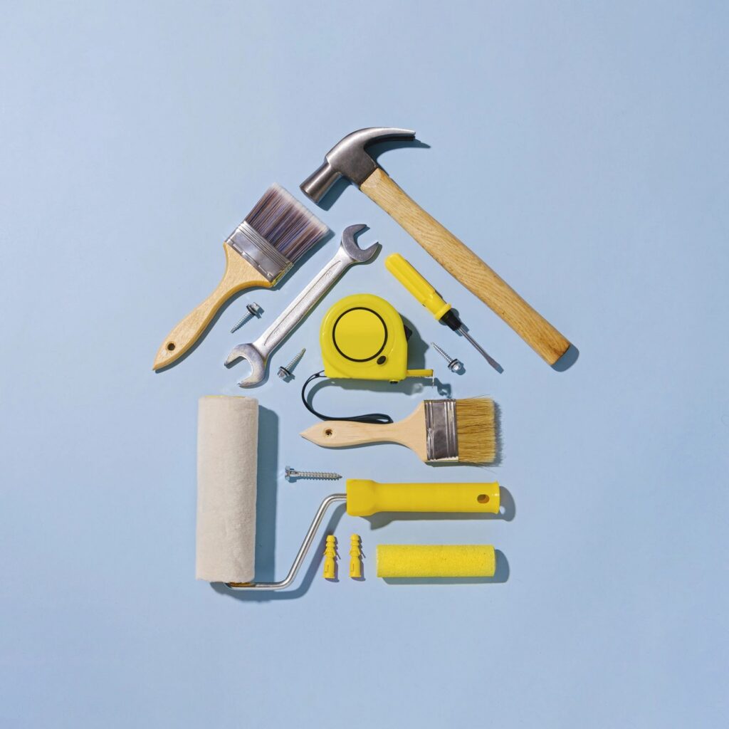 Creative flat lay still life with tools forming a small house